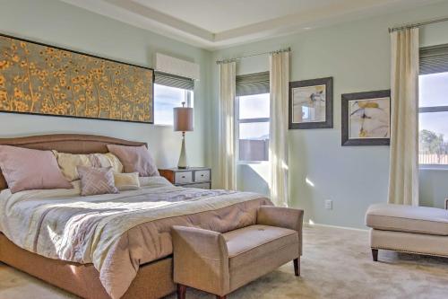 a bedroom with a bed and a chair and windows at Gorgeous Litchfield Oasis about 6 Mi to Luke AFB in Litchfield Park