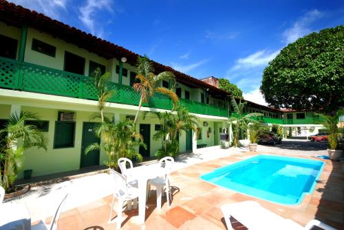 a view of the courtyard of a hotel with a swimming pool at Pousada Tapuia in Porto Seguro