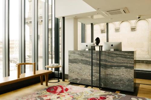 a lobby with two laptops on top of a desk at Market Street hotel in Edinburgh