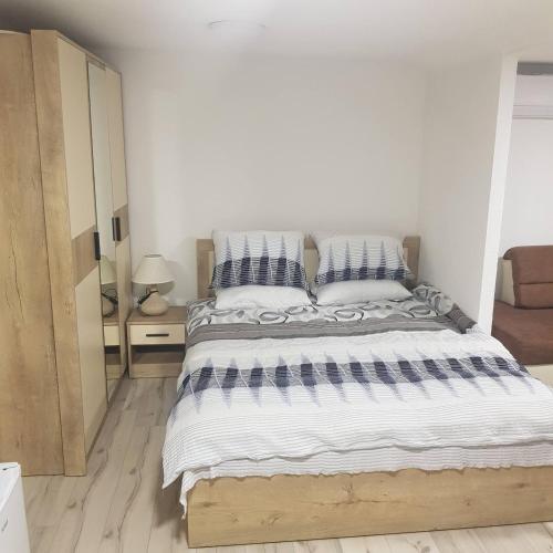 a bedroom with a large bed with striped pillows at Tiny House Veronia in Ohrid