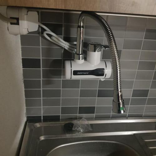 a kitchen sink with a drinking istg istg at Tiny House Veronia in Ohrid