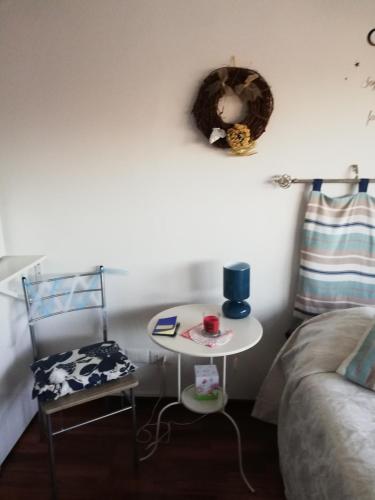 a bedroom with a table and a chair and a bed at Blue Apartment in Pescara