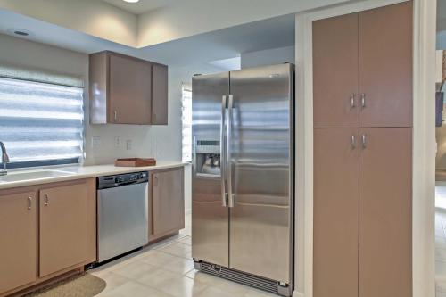a kitchen with a stainless steel refrigerator at Sand Dollar Jenson Beach Home with Pool Access! in Jensen Beach