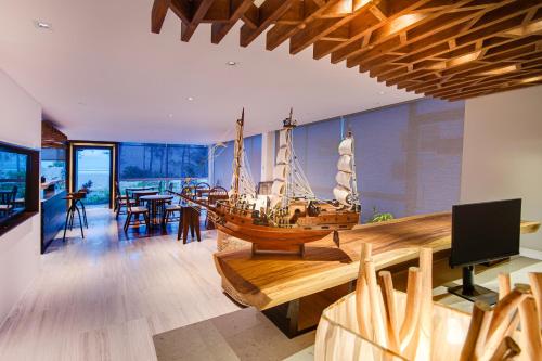 a large wooden boat on display in a living room at Seasalter Maldives in Hulhumale