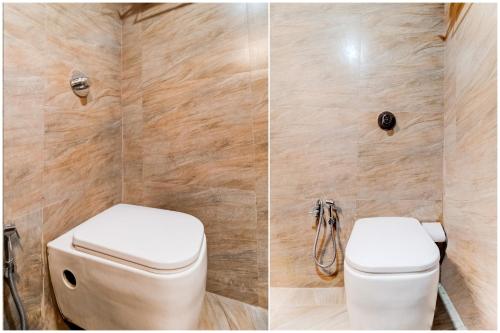a bathroom with a toilet and a wall of tile at Hotel Pearl's BKC Inn- Near Trade Centre, Visa Consulate in Mumbai