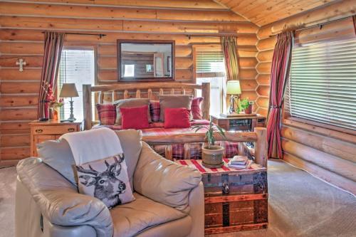 a living room with a couch and a bed at Rustic Cabin with Decks, Alpine Views and Pool Table! in Flagstaff