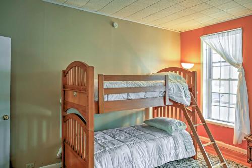 two bunk beds in a room with a window at Saratoga Springs Apt - Walk to Town and Race Track! in Saratoga Springs