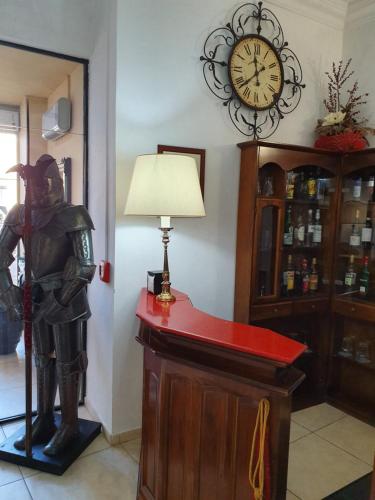 a statue of a knight standing on a counter with a clock at Hotel San Giorgio in Bergamo