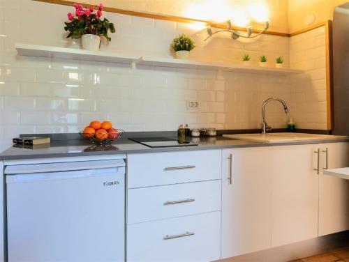 a kitchen with white cabinets and a sink at Casa Doña Justa in Tegueste