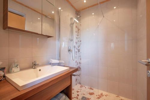 a bathroom with a sink and a shower at Ferienwohnungen Pfister in Zell am Ziller