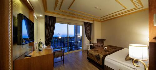 a hotel room with a bed and a balcony at Crystal Palace Luxury Resort & Spa - Ultimate All Inclusive in Side