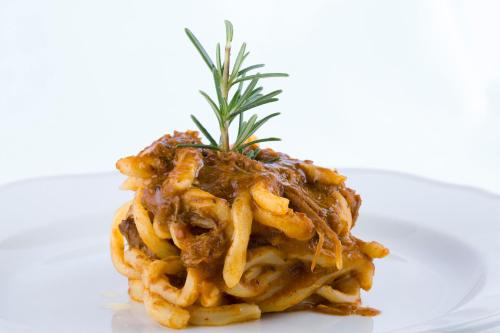 a plate of pasta with a pineapple on top at Podere Brizio in Montalcino
