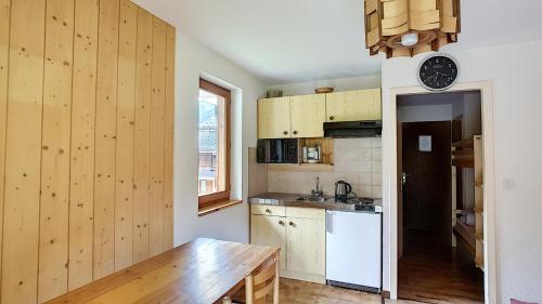 a kitchen with wooden walls and a wooden table at APPARTEMENT ST JEAN D'AULPS - PROCHE MORZINE - PIED DES PISTES - Moussière 8 in Saint-Jean-d'Aulps