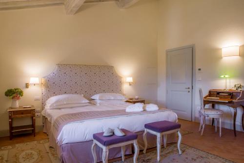 a bedroom with a large bed with purple accents at Podere Brizio in Montalcino