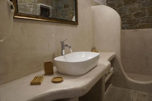 a bathroom with a white bowl sink on a counter at Casa Borealis in Naxos Chora