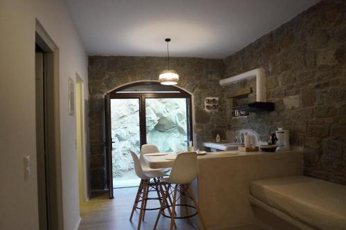 a kitchen with a table and chairs in a room at Casa Borealis in Naxos Chora