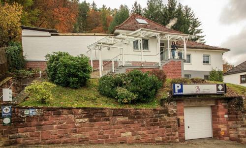 a man standing on the balcony of a house at Villa Bruderfels, Garni in Rodalben