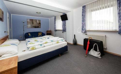 a bedroom with a large bed with blue walls at Villa Bruderfels, Garni in Rodalben