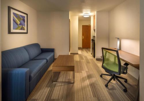 a living room with a couch and a desk and a chair at Holiday Inn Express Hotel & Suites Carson City by IHG in Carson City