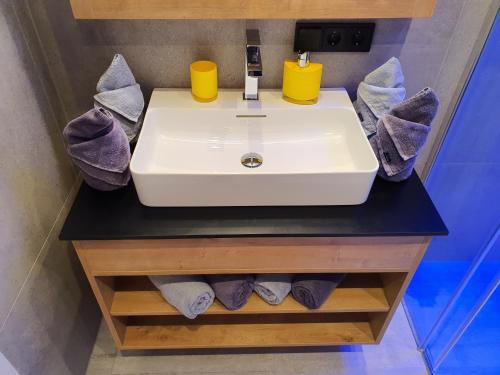 a bathroom with a sink and towels at Apartment Leontina in Kaprun