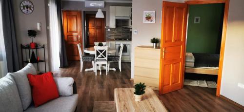 a living room with a couch and a dining room at Pannonia Apartman in Esztergom