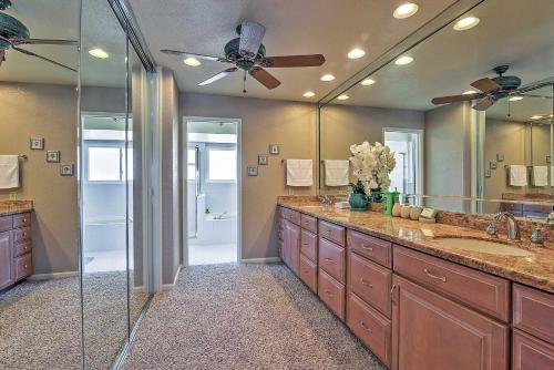 a bathroom with two sinks and a large mirror at Waterfront Discovery Bay Home Outdoor Bar and Dock in Discovery Bay