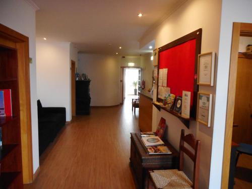 a room with a hallway with a living room at Agua Marinha ROSA- Hotel in Albufeira