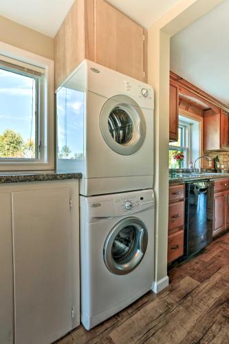 a kitchen with a washer and dryer in a kitchen at Waterfront Syracuse Home Deck, Fire Pit and Kayaks in Syracuse