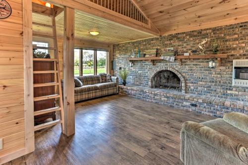 a large living room with a brick fireplace at Waterfront Syracuse Home Deck, Fire Pit and Kayaks in Syracuse