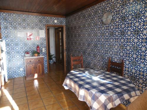 a bedroom with blue and white wallpaper and a bed at T3 em Sever do Vouga in Sever do Vouga