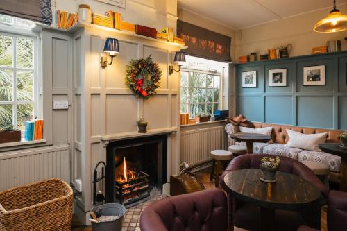 a living room with a fireplace and couches at The Black Boy in Oxford