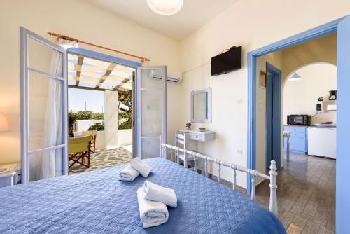 a bedroom with a bed with towels on it at Agnanti Studios in Naousa
