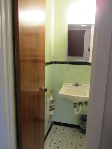 a bathroom with a sink and a toilet and a mirror at Budget Inn Ballinger in Ballinger