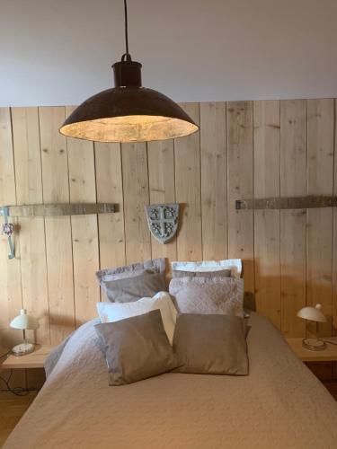 a bedroom with a bed and a large light fixture at Les Hirondelles in Wintzenheim