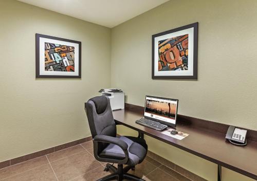 a office with a desk with a computer and a chair at Candlewood Suites Houston - Spring by IHG in Houston