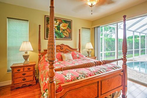 Un dormitorio con una cama con dosel y una ventana. en Naples Home with Pool, Extended Stays Welcome!, en Naples