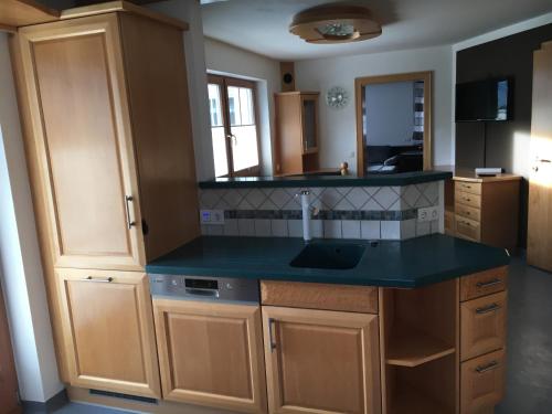 a kitchen with a blue counter top and a sink at Appartment Schmidl in Bischofshofen