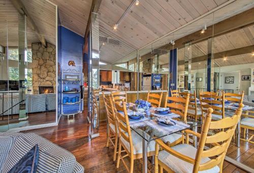 a dining room with a table and wooden chairs at Lake Arrowhead Cabin with Deck and Scenic Forest Views in Lake Arrowhead