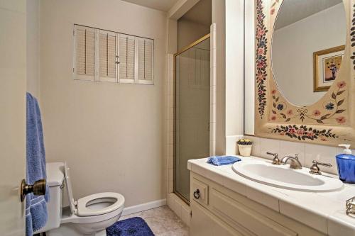 a bathroom with a toilet and a sink and a mirror at Lake Arrowhead Cabin with Deck and Scenic Forest Views in Lake Arrowhead