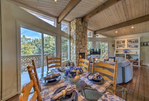 a dining room with a table and chairs in a room at Lake Arrowhead Cabin with Deck and Scenic Forest Views in Lake Arrowhead