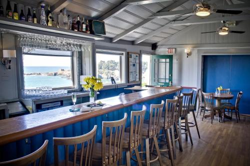 a bar in a restaurant with blue walls and chairs at Little River Inn in Little River