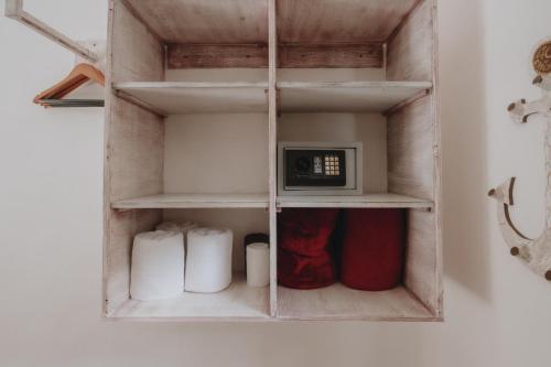 a wooden shelf with a microwave in a room at 40 Cañones in Mahahual