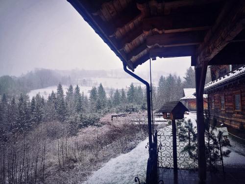 a room with a view of a snow covered field at Czarna Owca in Istebna