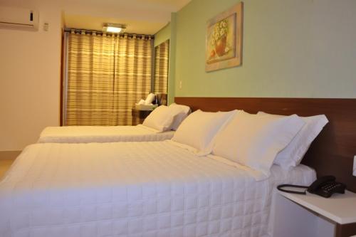 A bed or beds in a room at Hotel Saron