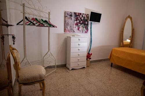 a bedroom with a dresser and a bed and a mirror at B&B Palazzo Armini in Rogliano