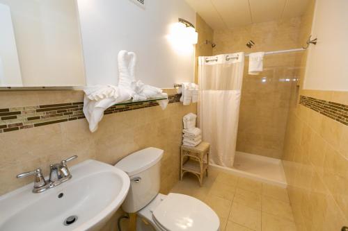 a bathroom with a toilet and a sink and a shower at Gondolier Motel - Wildwood in Wildwood Crest