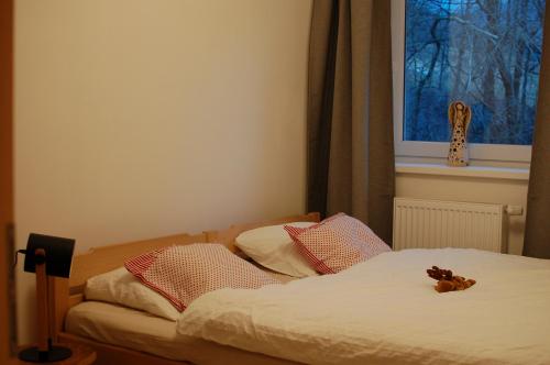a bedroom with a bed with a teddy bear on it at Apartman Masaryk in Lipova Lazne