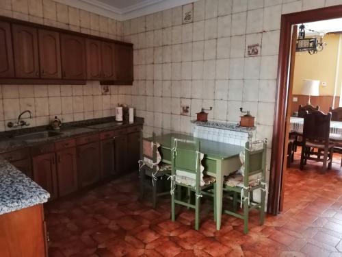 a kitchen with a table and chairs in it at Casa Rural El Capricho del Tejar in Cimanes del Tejar