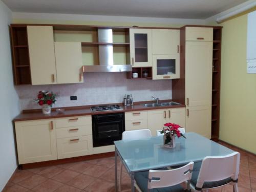 a kitchen with a blue table and white cabinets at CASA LAGHETTO in Bovegno