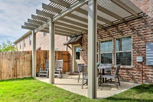 a pergola with chairs and a table on a patio at College Station Townhouse with Private Patio in College Station